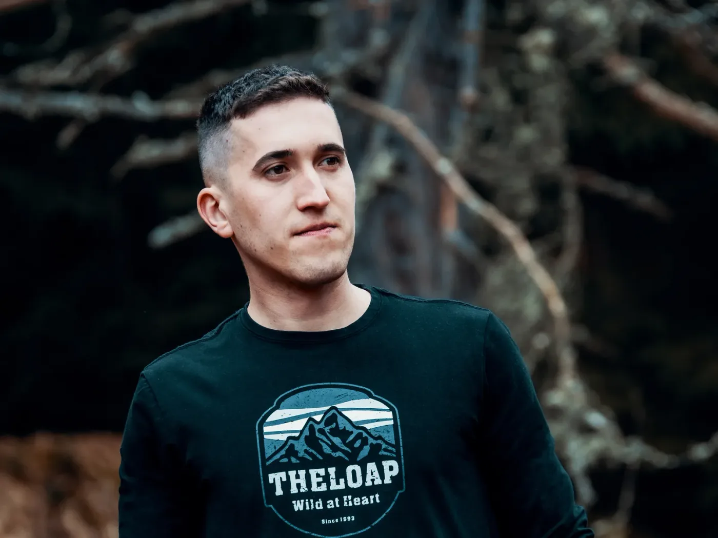 Me, Filip Majerčík, in a dark long-sleeved shirt, in an autumn forest, looking to the side.