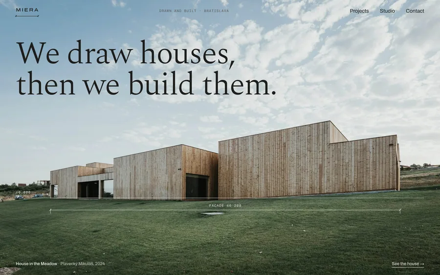 Screenshot. Miera, an architecture website template: a long timber house in a meadow (stock photograph), “We draw houses, then we build them.”